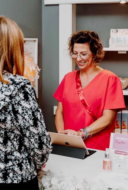 Laure, au comptoir de l'institut, avec une cliente